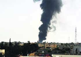 Oil on fire in libya: Plumes of smoke rise over an oil depot at the airport road in Tripoli, after clashes between rival militias, on Monday