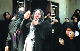 Relatives of Palestinian man Hussien Abu al-Naja mourn at his funeral at Khan Younis in the Gaza Strip on Monday