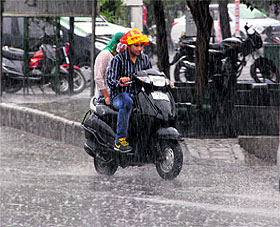 commuters brave the showers in Bathinda on Tuesday.