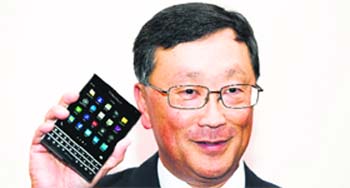 BlackBerry CEO John Chen holds up the unreleased Blackberry Passport device at their AGM in Waterloo in this file photo taken on June 19, 2014. BlackBerry is set to announce the acquisition of a German firm focused on voice and data encryption, burnishing its image in the eyes of ultra security conscious clients like government agencies.