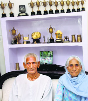 Parents of Dalbir Singh Suhag at their house in Bisaan village of Jhajjar on Tuesday.