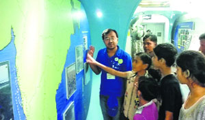 A science educator provides information to children on the Science Express at Kurukshetra station on Tuesday.