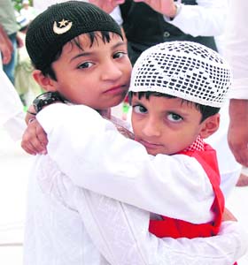 A gesture of love: Children embrace each other after offering prayers on the occasion of Eid-ul-Fitr at a mosque in Jalandhar on Tuesday