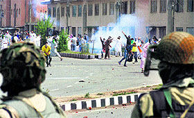 Security Forces use tear gas shells to disperse Kashmiri Muslim youth protesters during protesting and thrown on security forces after Eid al-Fitr prayers at main Eidgah in Downtown in Srinagar on Tuesday.