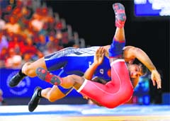 Indias Amit Kumar (top) throws South Africas Bokang Masunyane during the Freestyle 57 kg Wrestling quarterfinals at the 2014 Commonwealth Games in Glasgow, on Tuesday. Reuters