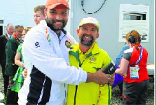 Harpreet Singh, silver-medallist in 25m rapid fire pistol event, with the gold-medallist David Chapman. Tribune photo