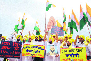 Members of the All India Anti-Terrorist Front pay tributes to Udham Singh on his 74th death anniversary at Jallianwala Bagh in Amritsar on Wednesday