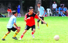 Players make a dash for the ball during a Pre-Subroto Cup Football Tournament tie at Sector 22, Chandigarh, on Wednesday