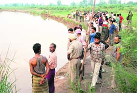 People gather at the mishap site on the bank of the Ghaggar at Dera Bassi on Wednesday