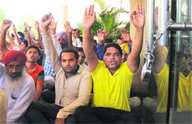 Protesting members of the ETT (TET-pass) Unemployed Teachers Union raise anti-establishment slogans after locking the doors of the Vikas Bhawan at Phase VIII in Mohali on Wednesday