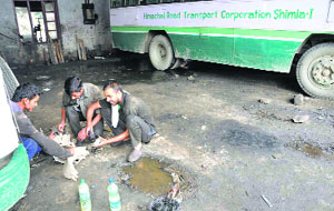 Mechanics at a divisional workshop of the HRTC at Taradevi in Shimla on Wednesday. 