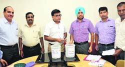 Jalandhar Improvement Trust officials during a draw of super deluxe HIG flats in Jalandhar on Wednesday. Tribune photo: Malkiat Singh