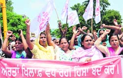 Activists of Istri Jagriti Manch hold a protest march to protest violenece against women at Company Bagh Chowk in Jalandhar on Wednesday. Tribune photo: Malkiat Singh