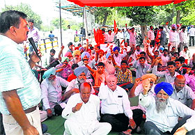 Workers hold a protest in front of the Mini-Secretariat in Ludhiana on Wednesday.