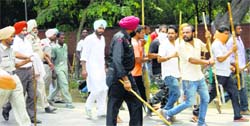 The police try to control the mob outside the office of the Talwandi Sabo Municipal Council on Wednesday. Tribune photo