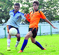 Players vie for the ball during a match in the Nemidas Memorial District Football League at Pavilion Ground in Dehradun on Wednesday. 