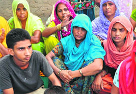 Sonu’s mother (centre) mourns the death at Faidan village near Sector 48, Chandigarh, on Thursday.