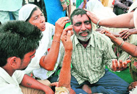 Sukhi’s grief-stricken father being consoled by relatives at Faidan village near Sector 48, Chandigarh, on Thursday