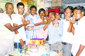 Villagers offer sweets to each other at Khuddan village in Jhajjar after Haryana grappler Bajrang Punia won the silver medal in the Commonwealth Games