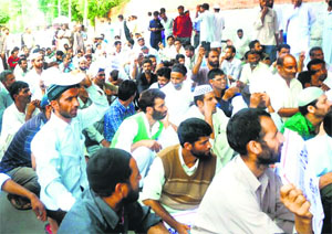 Members of the Public Health Engineering ITI Trained and CP Workers Union protest outside the residence of Chief Minister Omar Abdullah in Srinagar.