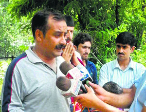 A member of the All Parties Migrants Co-ordination Committee speaks to the media after Kousar Nag Yatra was stopped by the state government