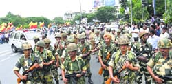 BSF jawans guard as members of Kannada organisations take part in a protest in Bangalore on Thursday. PTI 