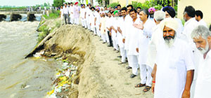 Rajasthan farmers inspect the damaged portion of canals in Punjab on thursday.