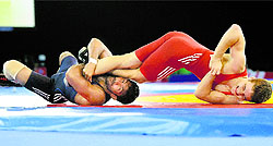 Yogeshwar Dutt employs his trademark scissor clinch. Of his four bouts on Thursday, he won three using what has become his signature move