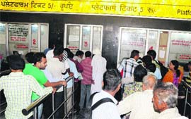 Passengers at a current booking window at the Amritsar railway station on Friday.