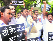 Protesters raise slogans against introduction of the C-SAT in UPSC exams in New Delhi on Friday.