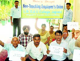 Non-teaching staff members of Lajpat Rai DAV College, Jagraon, hold a protest.