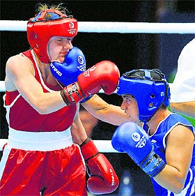 Pinki Rani (blue) lands a punch on the face of her opponent, Michaelas Walsh of Ireland, in the 51kg semifinal on Friday.