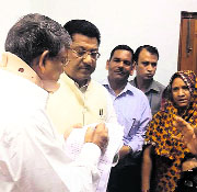 Chief Minister Harish Rawat meets family members of Tarun Kumar in Dehradun on Friday.