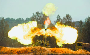 An Israeli mobile artillery unit fires towards the Gaza Strip on Friday.