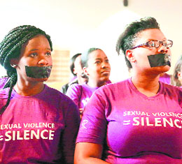 Women with tape covering their mouths take part in a silent protest in Durban to highlight rape survivors right to anti-HIV treatment, on Friday.
