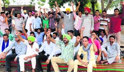 PRTC workers stage a protest at the bus stand in Bathinda on Saturday. Tribune photo