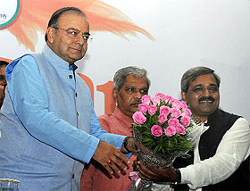 Union Finance Minister Arun Jaitley greeted by Delhi BJP president Satish Upadhaya (R) durng 'Budget Par Charcha' in New Delhi on Saturday.