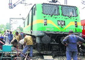 Workers try to put the engine back on rails