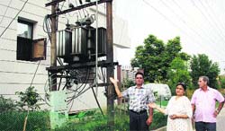 Residents show the electricity transformer set up adjoining the house in Chhoti Baradari, Part-1, in Jalandhar on Saturday. Photo: Sarabjit Singh