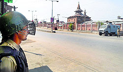 Paramilitary personnel stand guard in front of Jamia Masjid during restrictions in Srinagar on Saturday