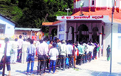 Pilgrims stand in a queue at the Buddha AmarNath Shrine in Poonch