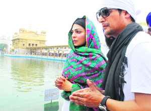 Actors Jimmy Shergill and Neeru Bajwa pay obeisance at the Golden Temple during the promotion of the upcoming film Aa Gaye Munde UK De in Amritsar on Sunday.