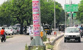 Posters pasted on an electricity pole at Phase I in Mohali