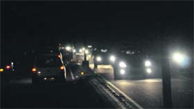 Vehicles move on a poorly lit road in Chandigarh