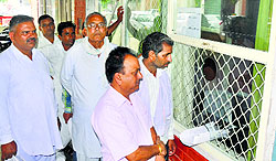 Residents wait for their turn to get token for registry in Karnal on Thursday