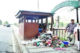 Stink greets park visitors: Garbage lies scattered on Zero Bridge in front of the Jhelum View Park in Srinagar on Sunday