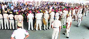 Police personnel surround the agitating members of the 3442 Adhyapak Union, Punjab, at Dana Mandi in Ludhiana on Sunday.