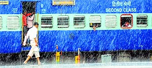 A vendor braves downpour to sell tea at the Ludhiana railway station.