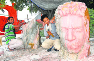 Sculptors Harpal (L) and Mandeep Maan at work