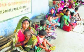 Villagers take shelter at a government school at Birpur, Bihar, on Sunday.